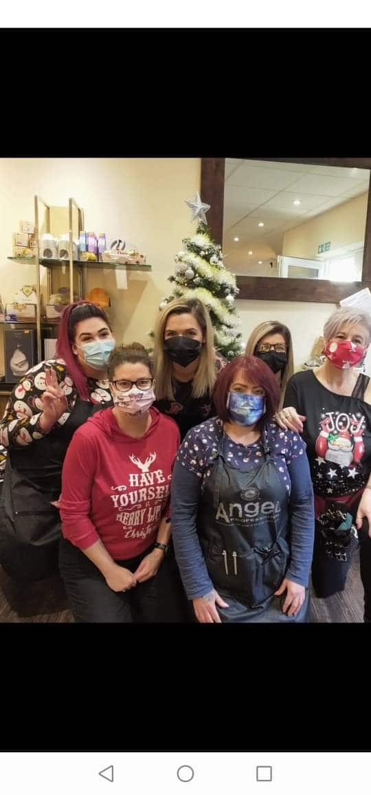 Lilly's Hair Salon team posing together inside the salon