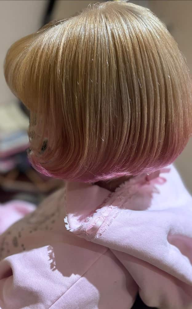 Close-up of blonde bob with pastel-pink dipped tips