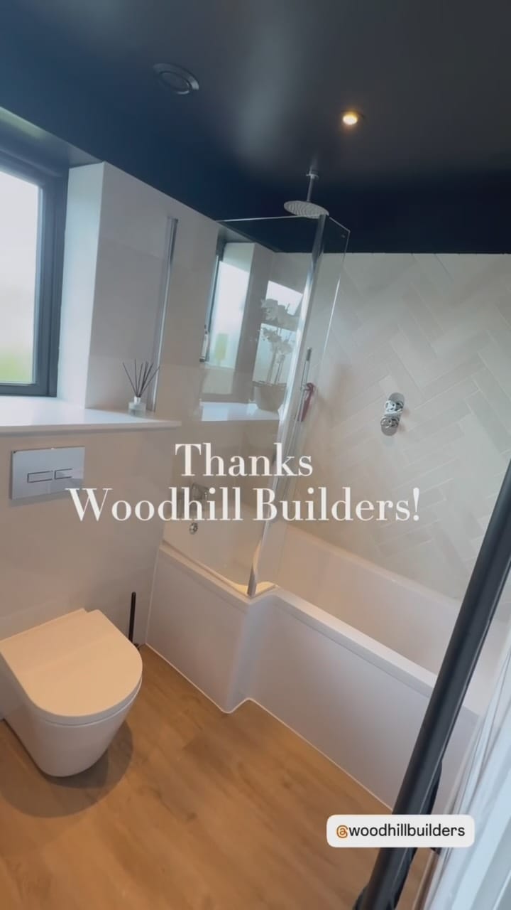 Completed modern bathroom with herringbone tiles and oak flooring