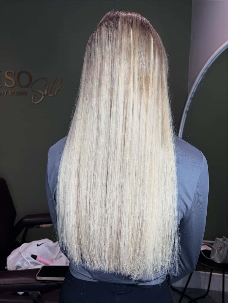 Long platinum-blonde hair extensions with a seamless root blend