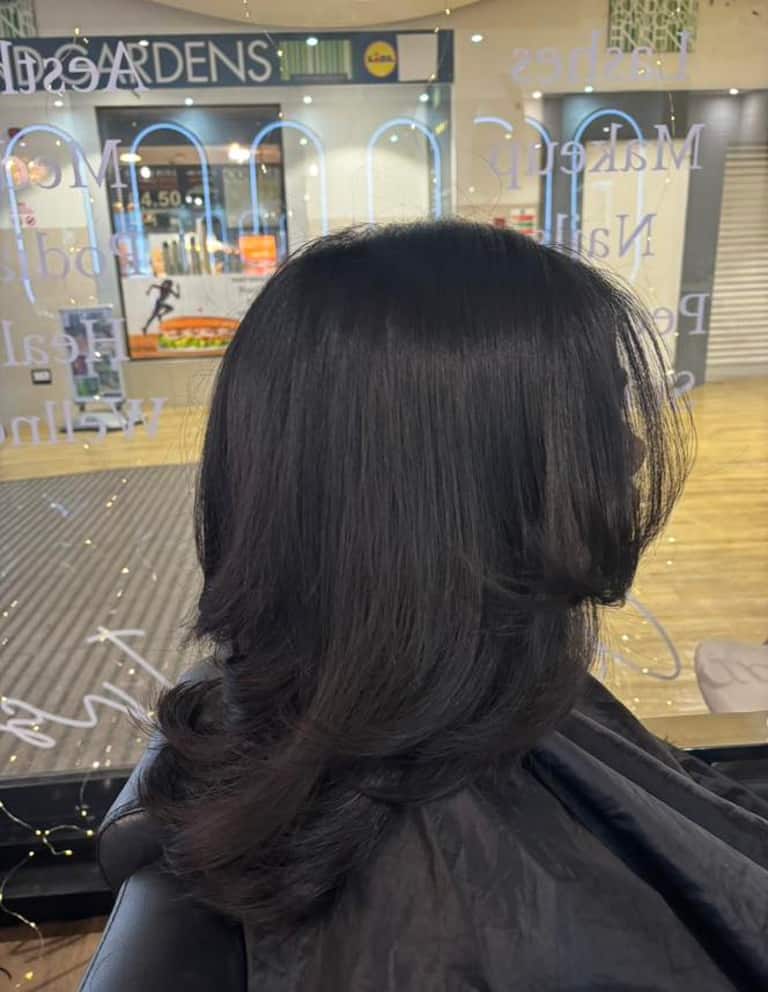 Dark brown hair with 70s-inspired flicked blow-dry