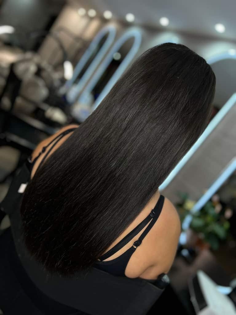 Long jet-black hair with a high-shine sleek finish