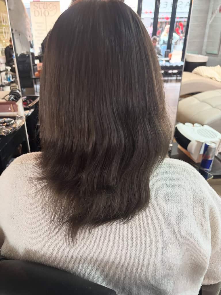 Layered medium-length hair refreshed with a deep brunette colour