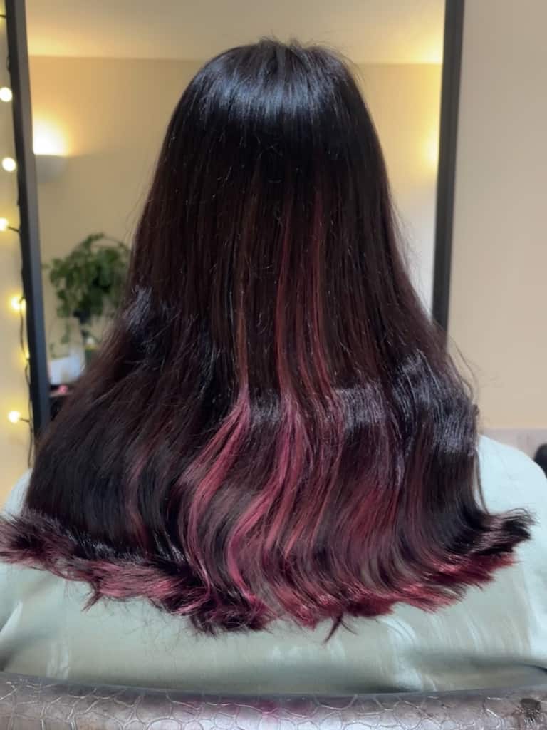 Dark brunette hair with hot-pink peekaboo panels underneath