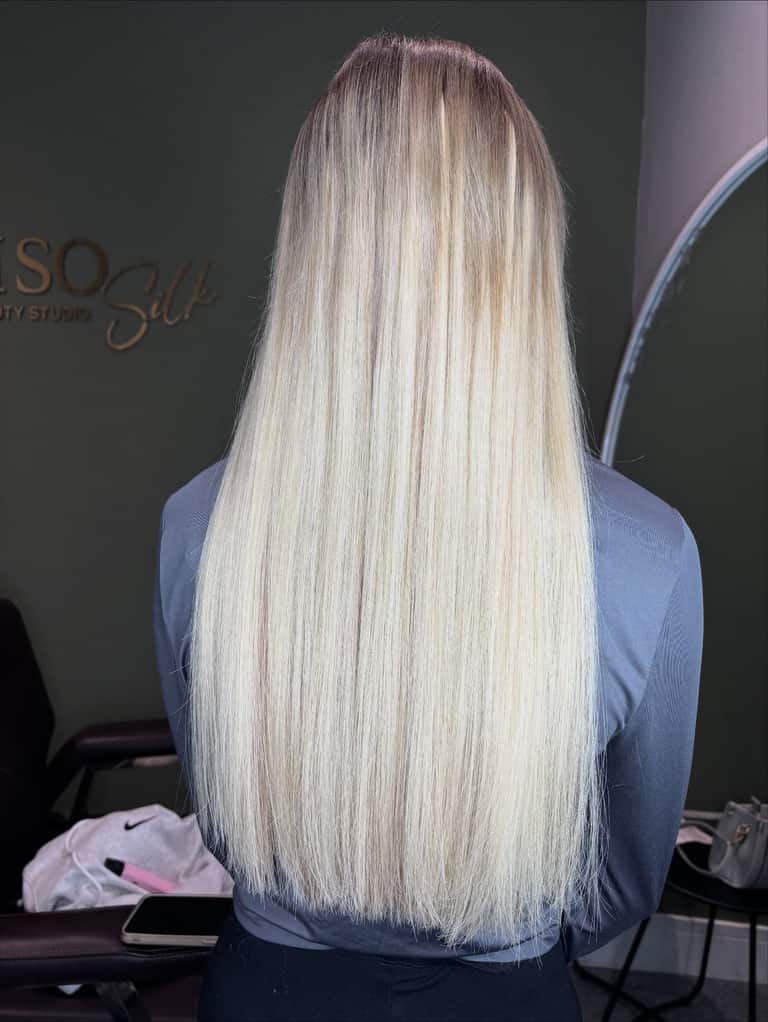 Long platinum-blonde hair extensions with a seamless root blend