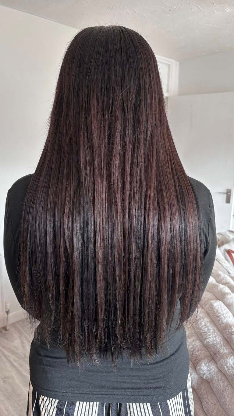 Long silky dark brown hair extensions with a smooth straight finish