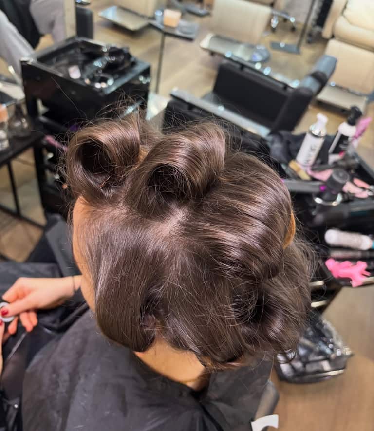 Hair sectioned and clipped during a styling appointment