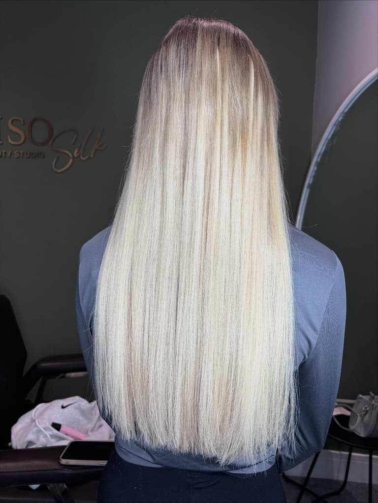Long platinum-blonde hair extensions with a seamless root blend