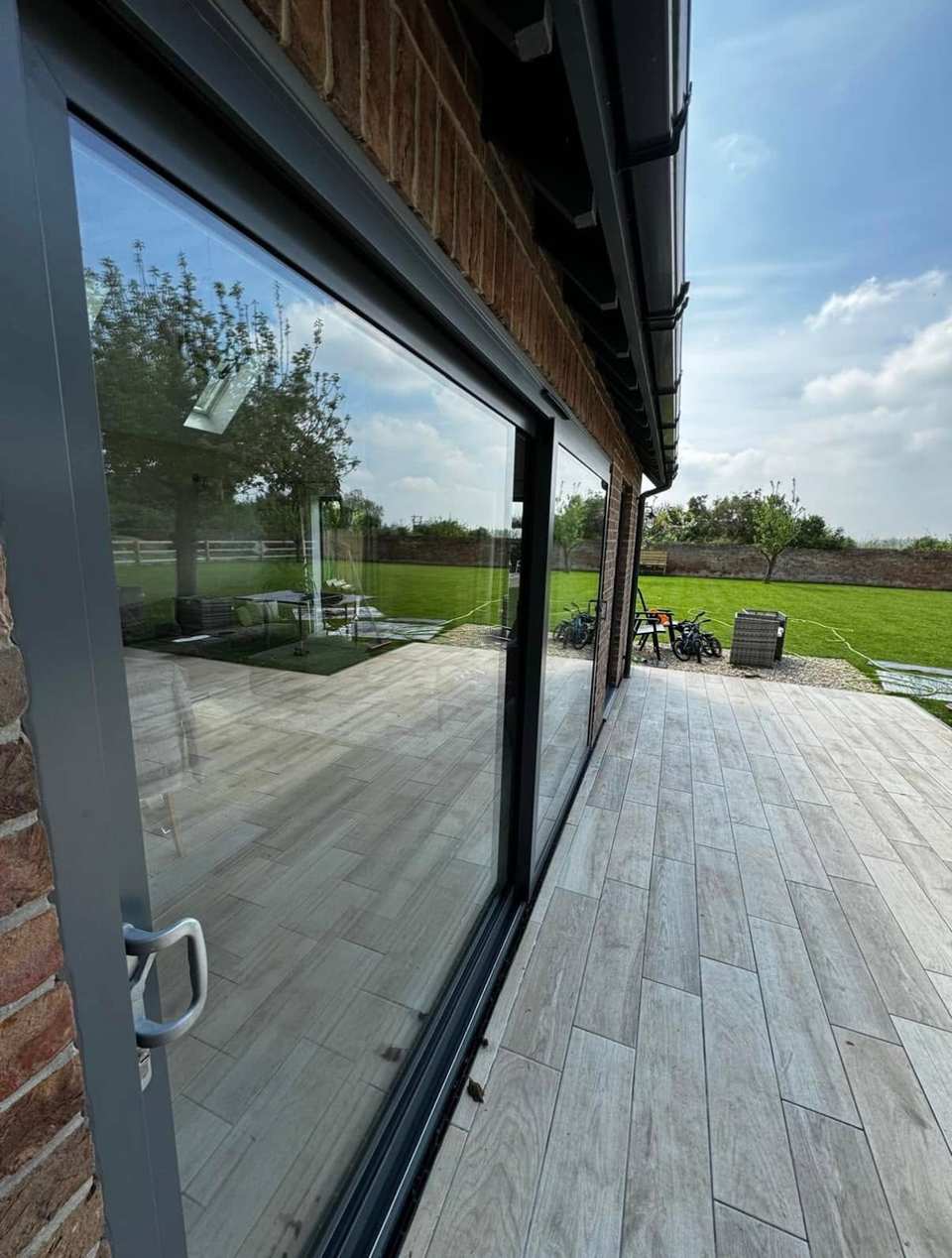 Streak-free glass sliding doors reflecting a garden after cleaning