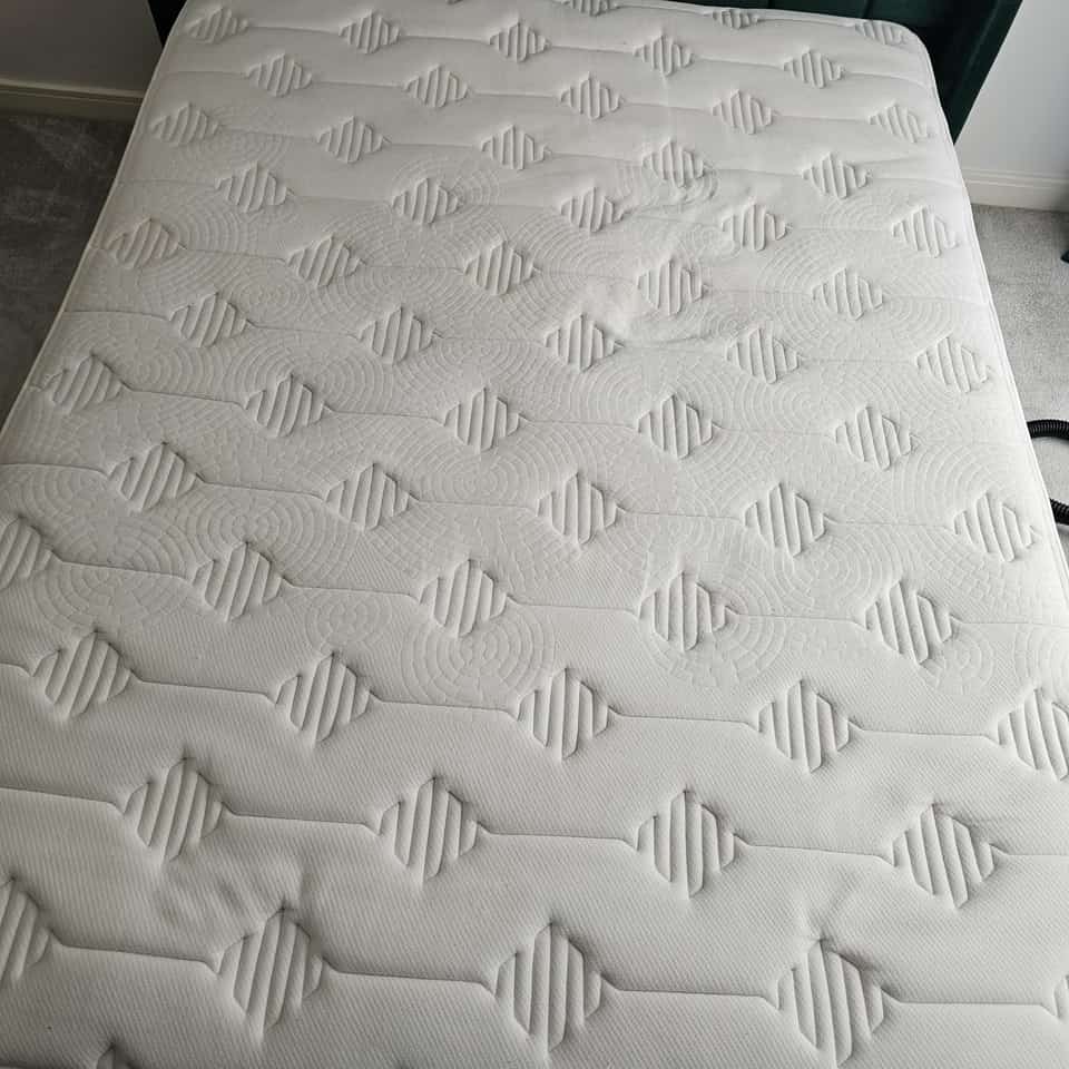 Clean double mattress with stains removed after professional cleaning.