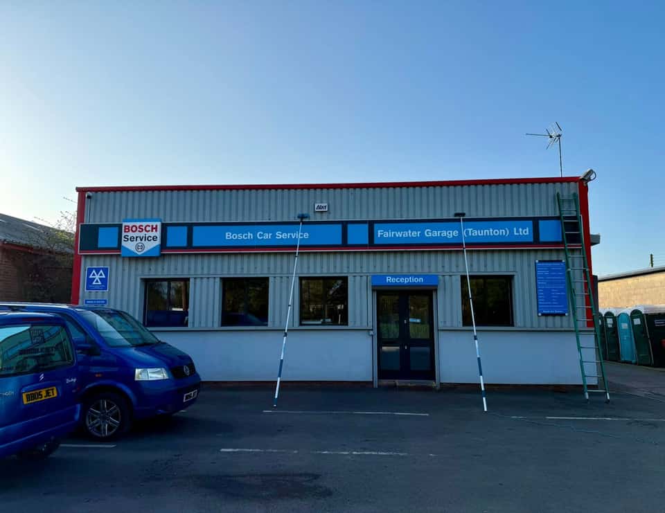 Commercial garage unit with the Bubble Jets van and reach poles outside