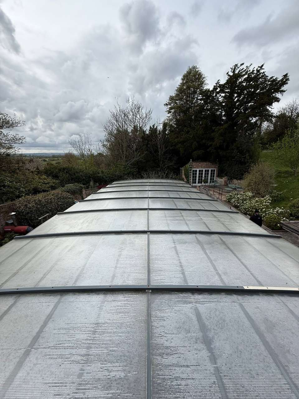 Top-down view along a cleaned glazed pool enclosure roof
