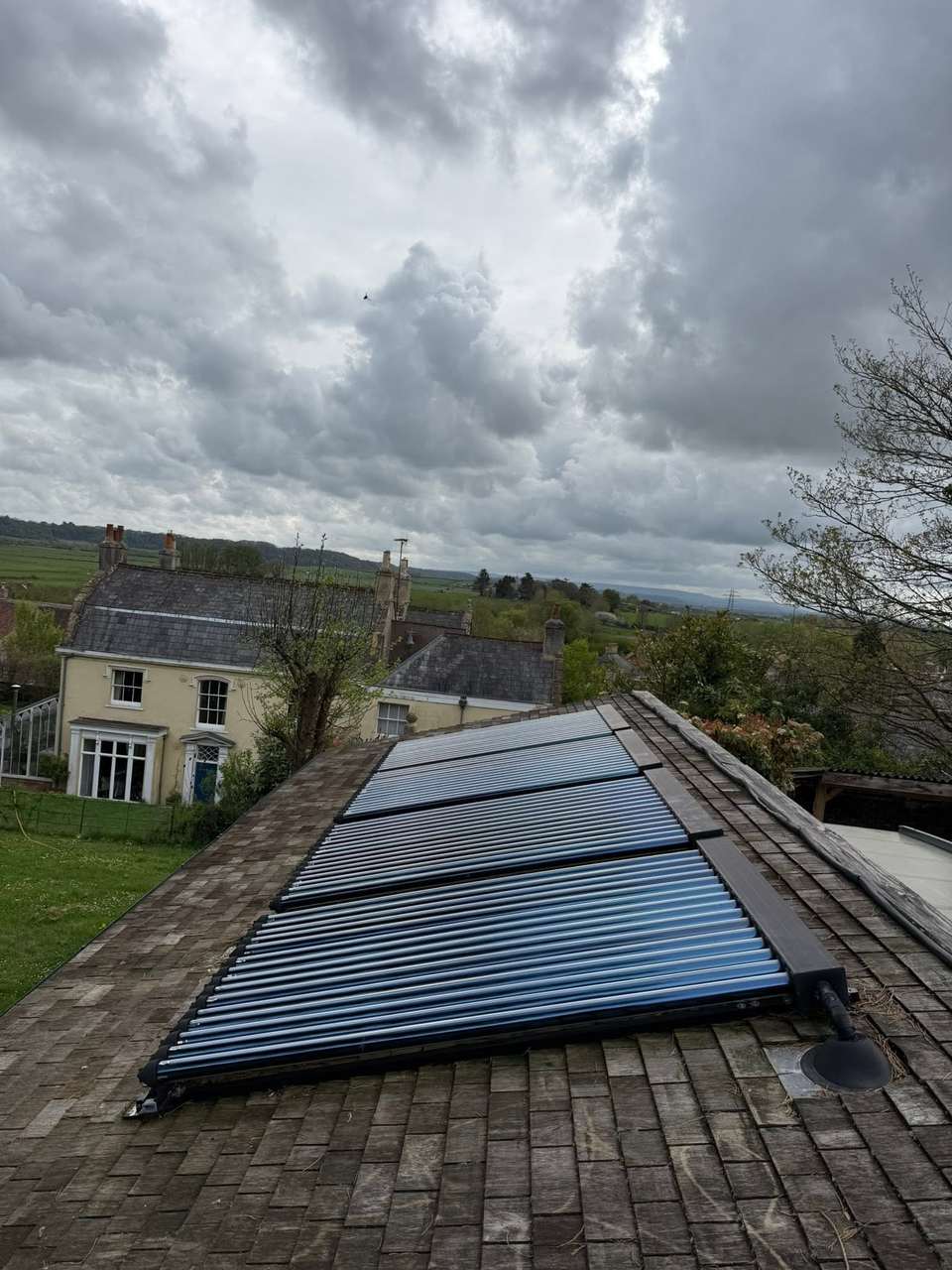 Solar panels on a tiled roof cleaned with a pure water system