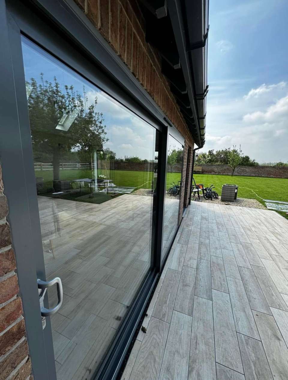 Streak-free glass sliding doors reflecting a garden after cleaning