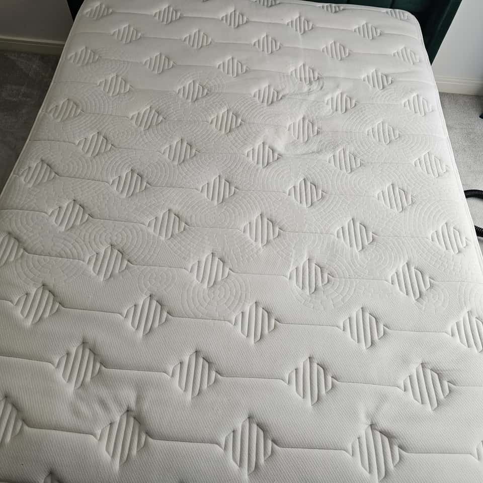 Clean double mattress with stains removed after professional cleaning.
