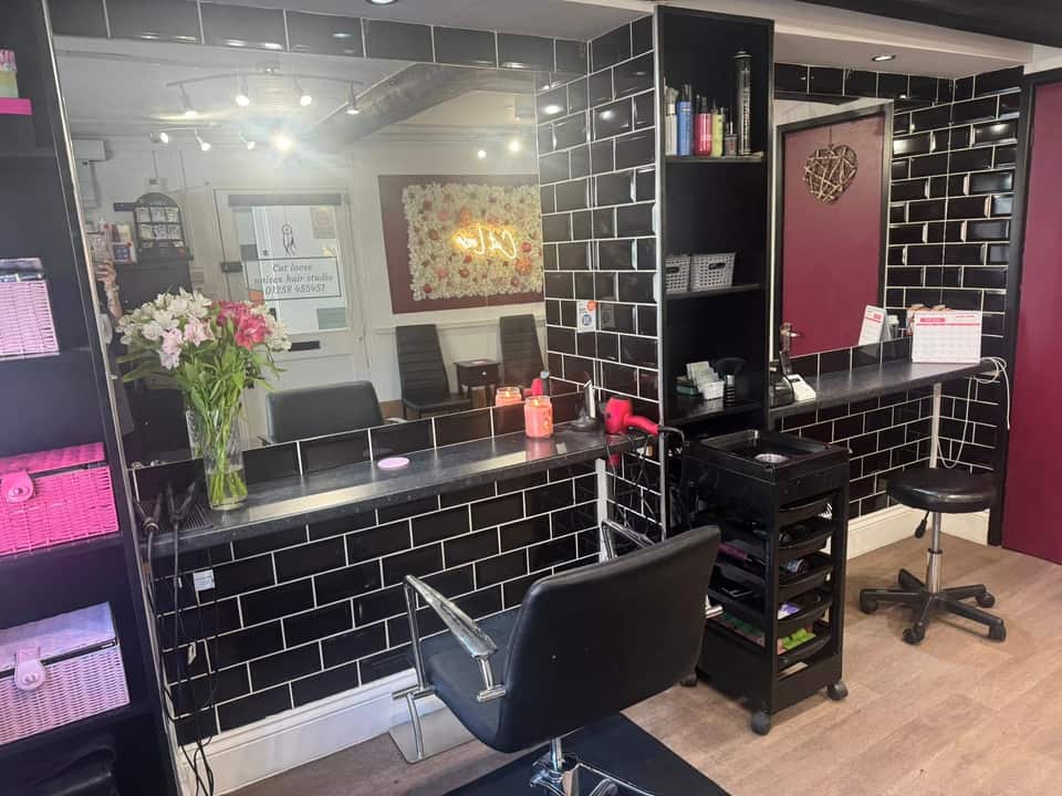 Salon styling station with feature wall reflected in the mirror