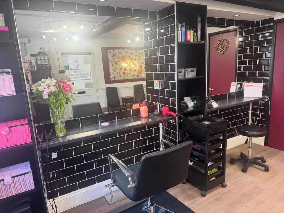 Styling station with black metro tiles, mirror and fresh flowers
