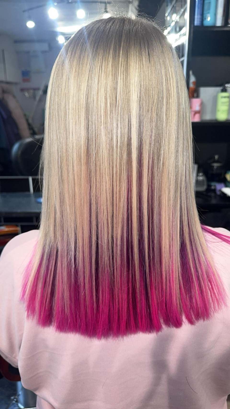 Blonde hair with vivid magenta and pink dip-dyed ends, expertly blended