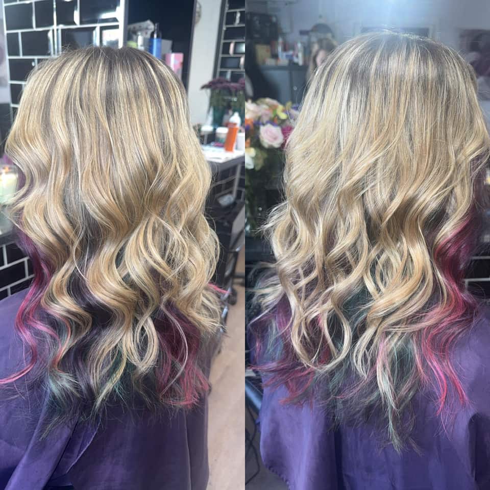 Beachy curls on blonde hair with hidden pink and teal underlights