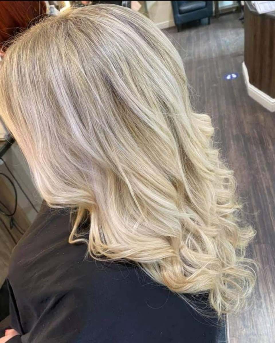 Long blonde hair with soft highlights and curled styling — finished result
