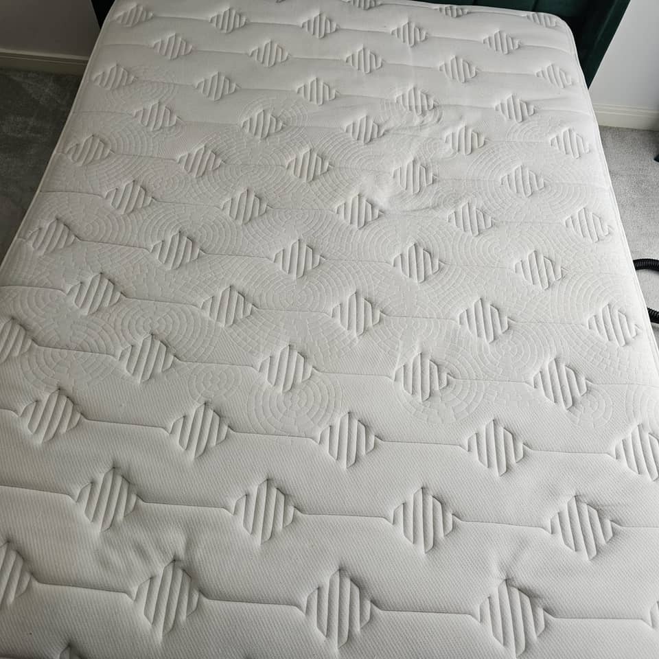 Clean double mattress with stains removed after professional cleaning.