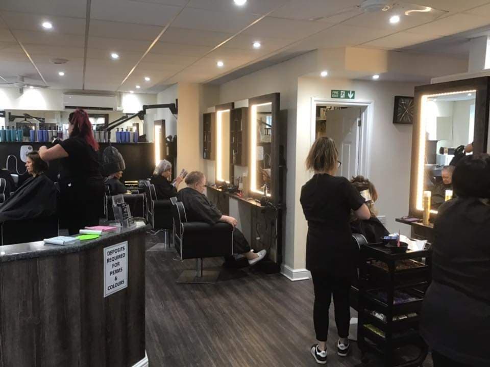 Stylists working with clients inside Lilly's Hair Salon, Blandford Forum