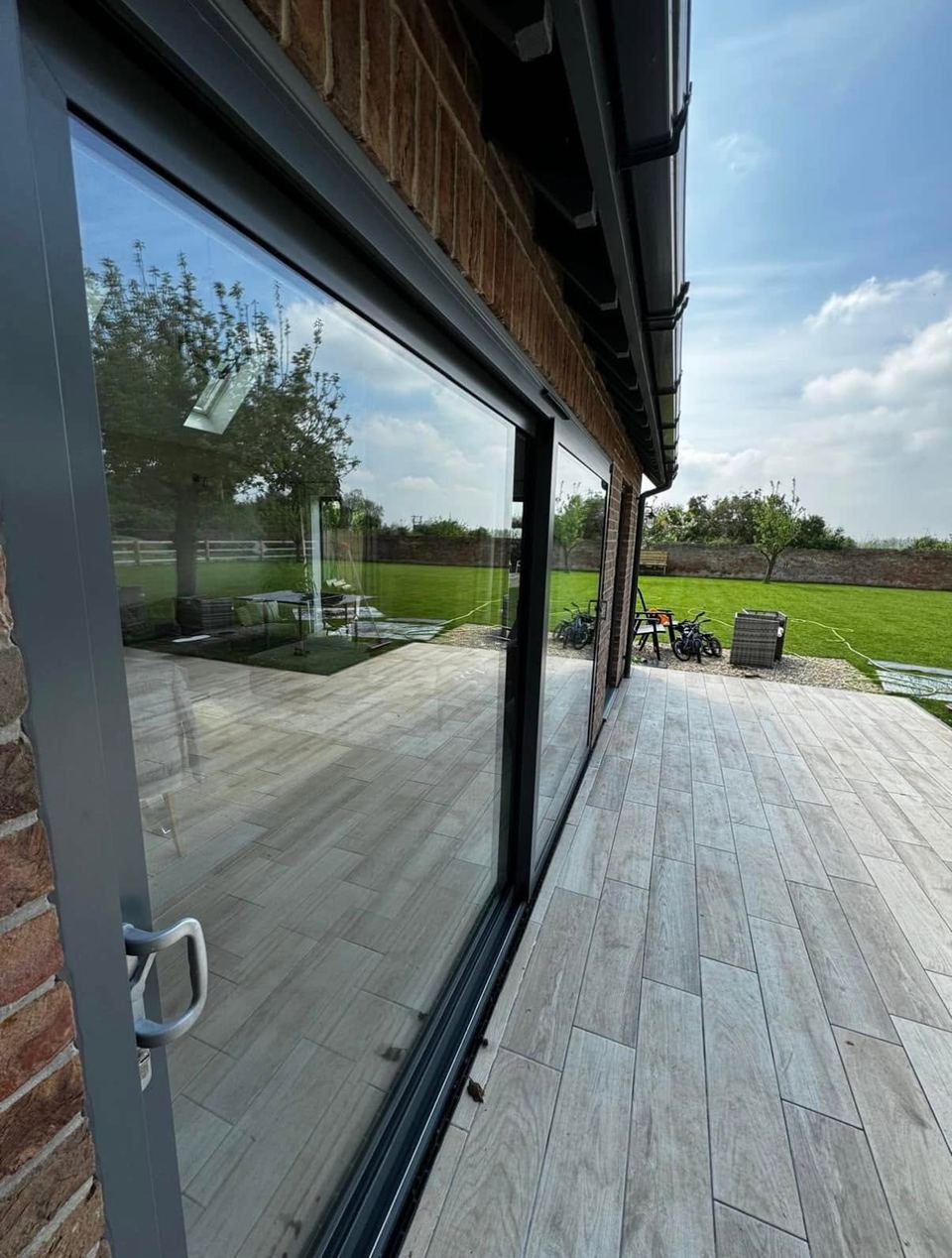 Clean paving and patio outside a home with spotless glass doors