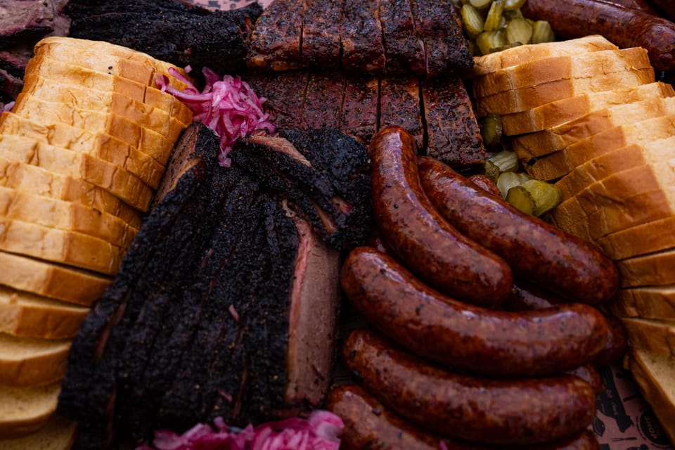 Sliced brisket and sausage on butcher paper