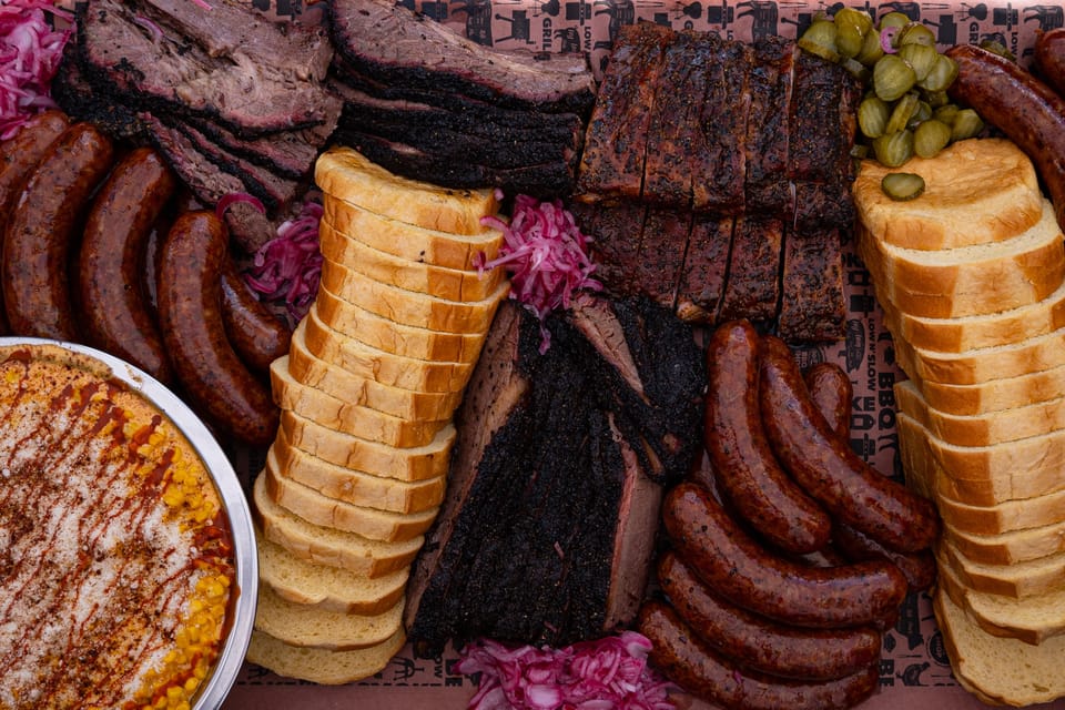 Wide Wilson's BBQ spread with brisket, ribs and sausages