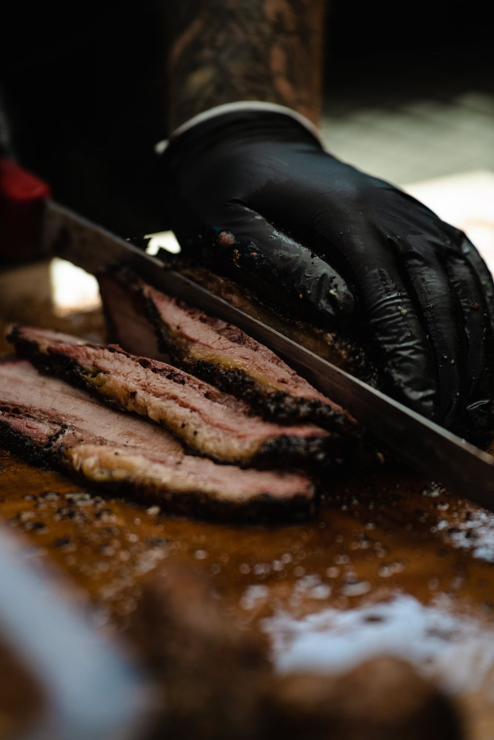 Knife slicing through a Wilson's BBQ brisket