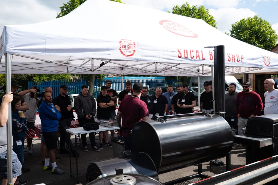 Wilson's BBQ class group gathered around the smokers