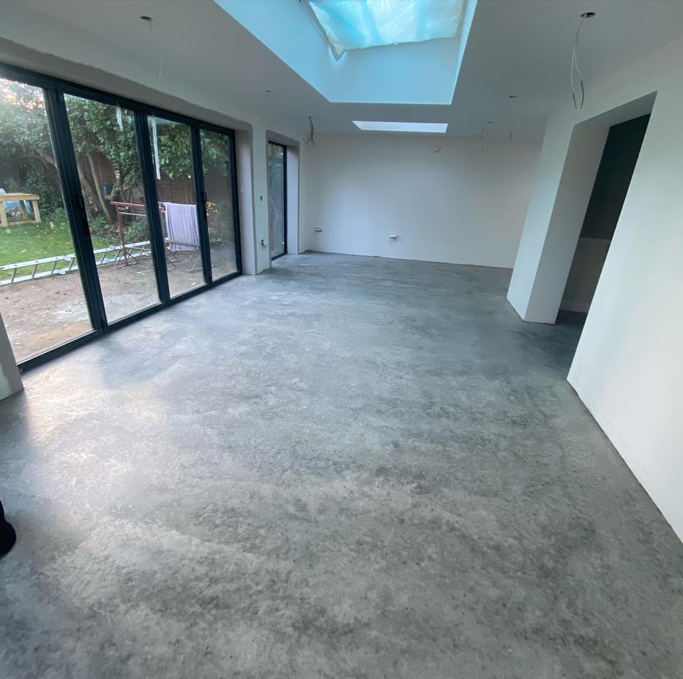 Open-plan extension interior with bifold doors and skylight during second fix