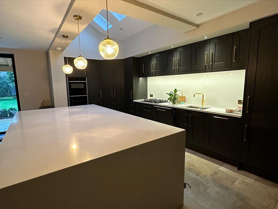 Kitchen extension with vaulted ceiling skylight and dark shaker units